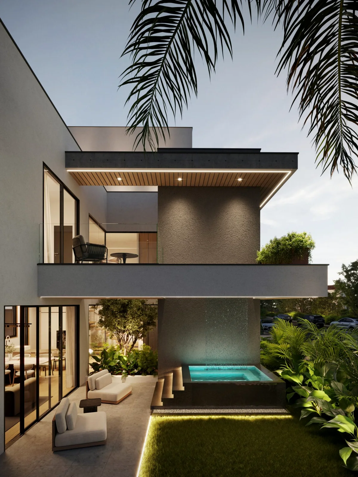 Two-storey villa at dusk with a lit plunge pool and timber soffit