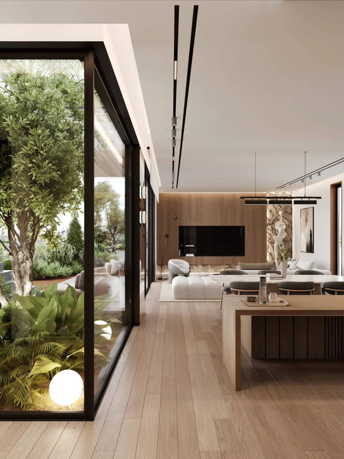 Open-plan living space in oak and stone beside a planted glass courtyard